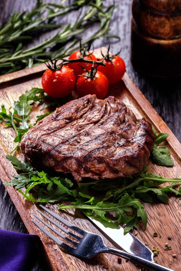 Juicy portions of grilled fillet steak served with tomatoes and royalty free stock images Juicy portions of grilled fillet steak served with tomatoes and royalty free stock images
