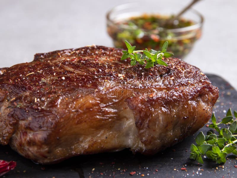 Juicy Roasted Beef Steak with Spices and Thyme, Close Up Stock Image