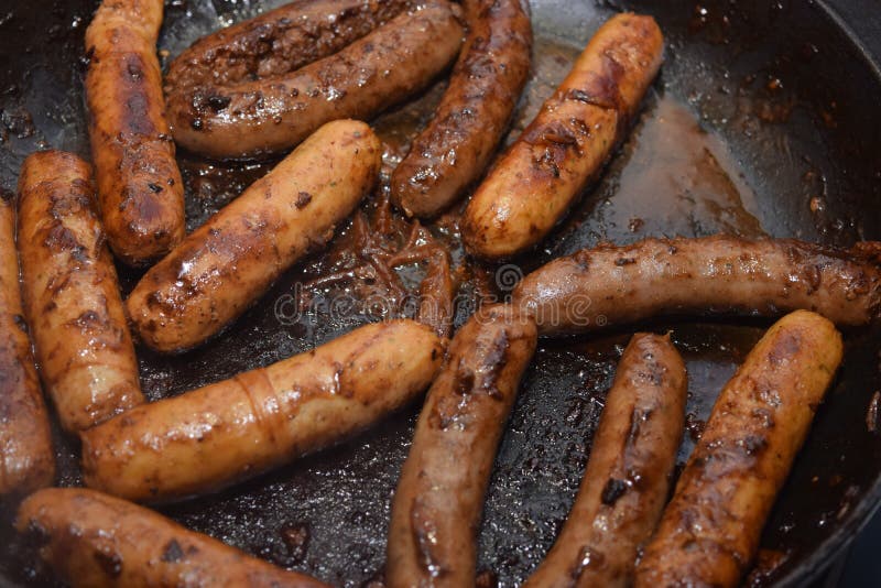 Juicy Sausages Straight From Grill On Green Plate From Hot Barbecue