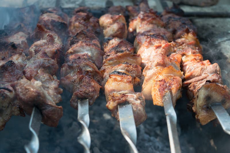 Juicy skewers being prepared on coals in a rural area in Moldova