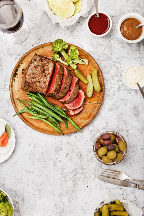 Juicy Steak with Vegetable Garnish and Sauces for Meat Stock Image