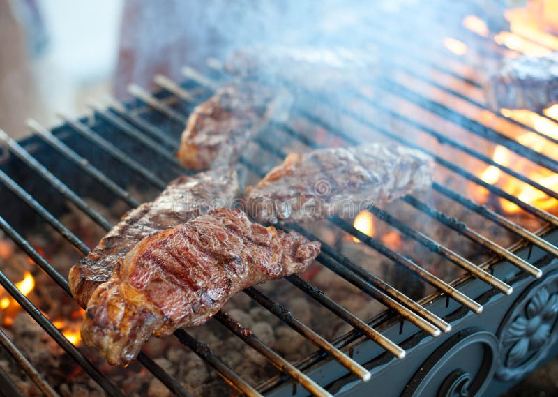 Juicy Steaks from Marbled Veal are Roasted on a Grill Stock Photo