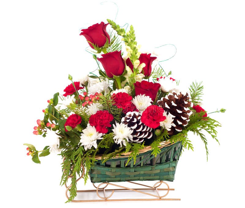 Julbukett av blommor i slädekorg arkivbild