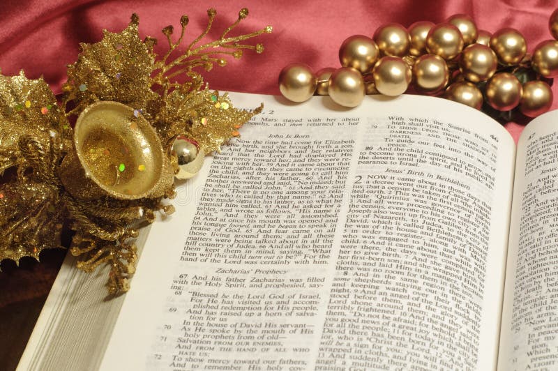 Bible open to the Christmas passage of Luke 2 with gold decor. Bible open to the Christmas passage of Luke 2 with gold decor