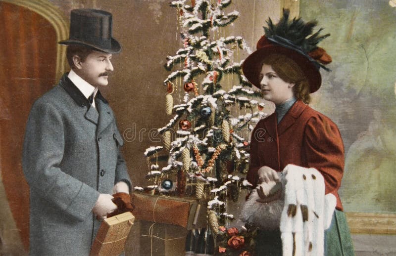 GERMANY- CIRCA 1915: Vintage christmas card printed in Germany in 1915 with loving couple beside a christmas tree with presents, circa 1915. GERMANY- CIRCA 1915: Vintage christmas card printed in Germany in 1915 with loving couple beside a christmas tree with presents, circa 1915.