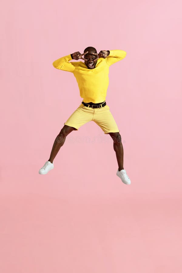Jump. Happy man jumping in air, screaming on pink background stock images Jump. Happy man jumping in air, screaming on pink background stock images