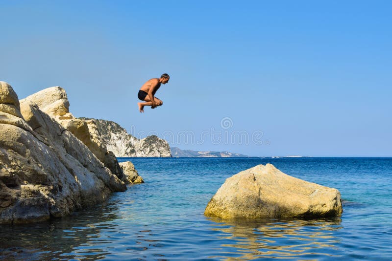 Jump into the sea. stock image. Image of rock, pure - 116627467