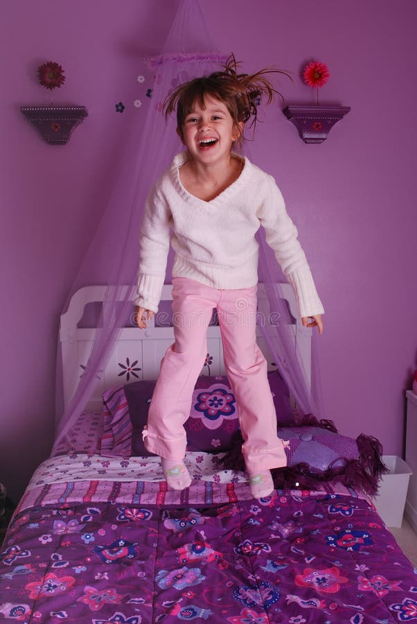 Two women jumping on bed stock photo. Image of indoors 5930098