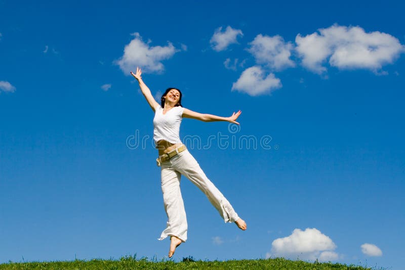 Jumping girl in meadow