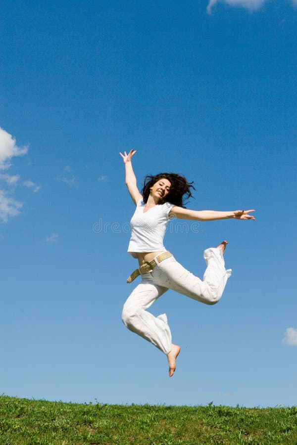 Jumping girl in meadow