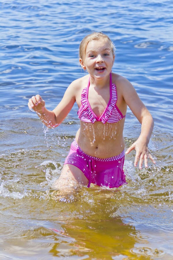 Jumping girl in pink swimsuit stock image Jumping girl in pink swimsuit stock image