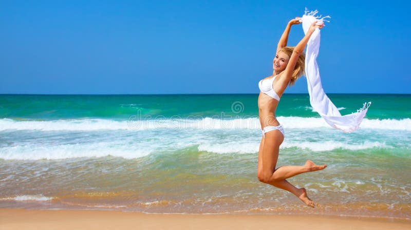 Jumping happy girl on the beach