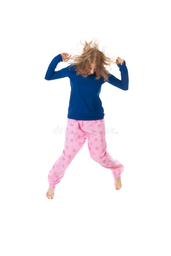 Young woman is jumping in blue and pink pajamas. Young woman is jumping in blue and pink pajamas