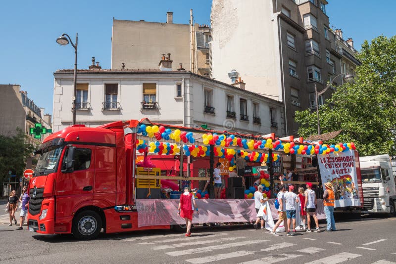 Gay Pride Parade Day. Colorful red truck with balloons and `Zerophobia` sign