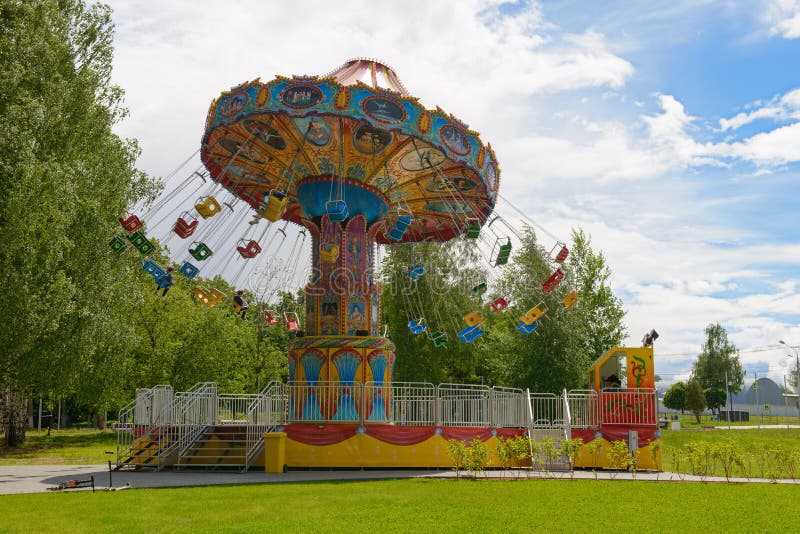 June 10, 2018: Several children ride a carousel in an amusement park. Cheboksary. Russia.