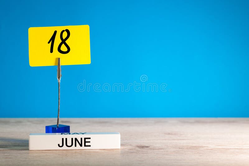 June 18th. Day 18 of June Month, Calendar on Table with Blue Background