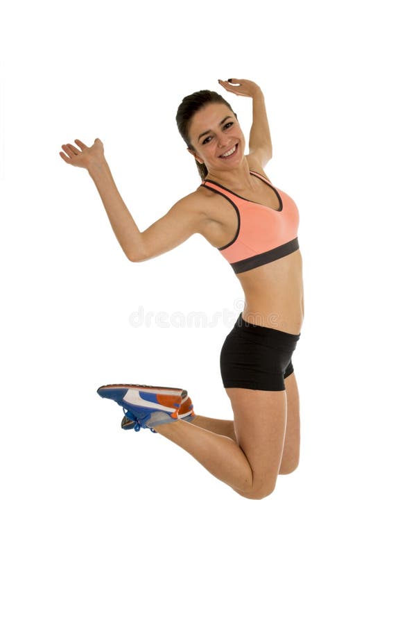 Young attractive fitness trainer woman jumping high excited and happy wearing clothes isolated on white background in healthy lifestyle and body energy concept. Young attractive fitness trainer woman jumping high excited and happy wearing clothes isolated on white background in healthy lifestyle and body energy concept