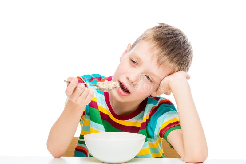 Junge, der Brei, Kinderbild lokalisiert auf Weiß isst. Junge, der Brei, Kinderbild lokalisiert auf weißem Hintergrund isst