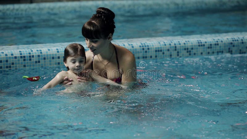 Junge Eltern im Pool seinen Sohn unterrichtend, unter Wasser zu schwimmen