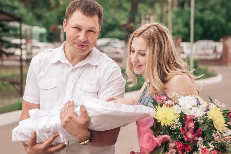 Junge Eltern mit neugeborener Babystellung auf Straßen lizenzfreie stockfotografie