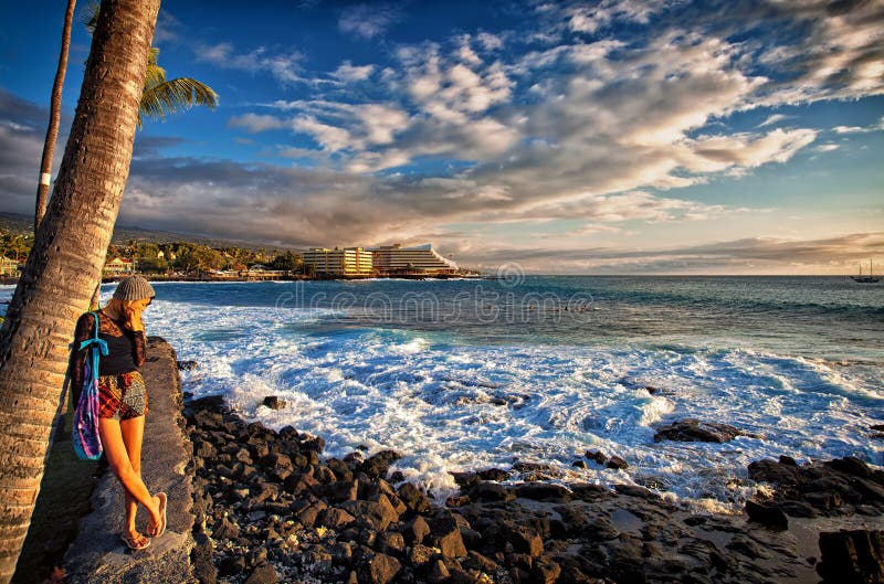 Female at sunset on Kailua-Kona coast in Hawaii, USA. The Royal Kona Resort Hotel along Kailua Bay. Female at sunset on Kailua-Kona coast in Hawaii, USA. The Royal Kona Resort Hotel along Kailua Bay.