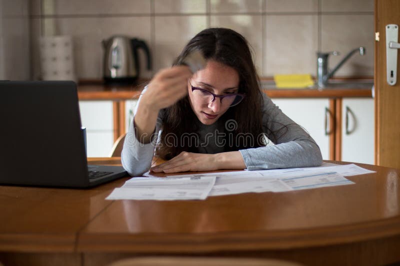 Junge Frau, die darum kämpft, die Rechnungen zu bezahlen, die sich Sorgen um Inflation machen lizenzfreies stockbild
