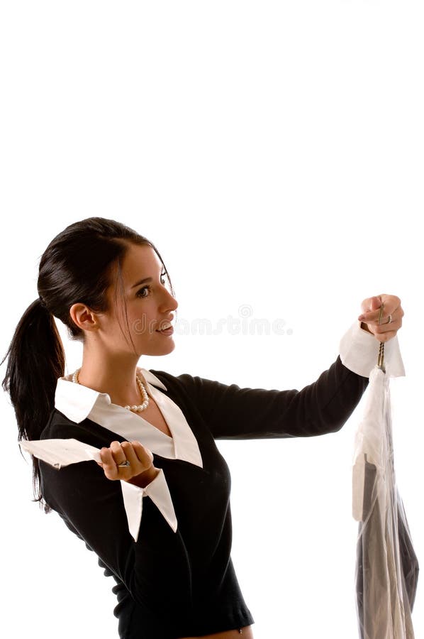 Side view of a young beautiful brunette woman with her dry cleaning in one hand and a receipt in the other. She looks concerned about her receipt. Side view of a young beautiful brunette woman with her dry cleaning in one hand and a receipt in the other. She looks concerned about her receipt.