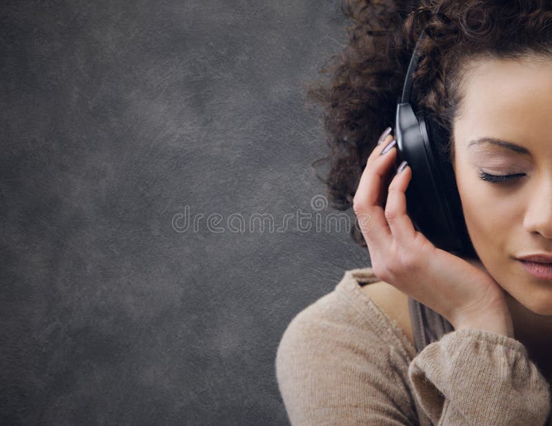 Young beautiful woman enjoying music. Young beautiful woman enjoying music