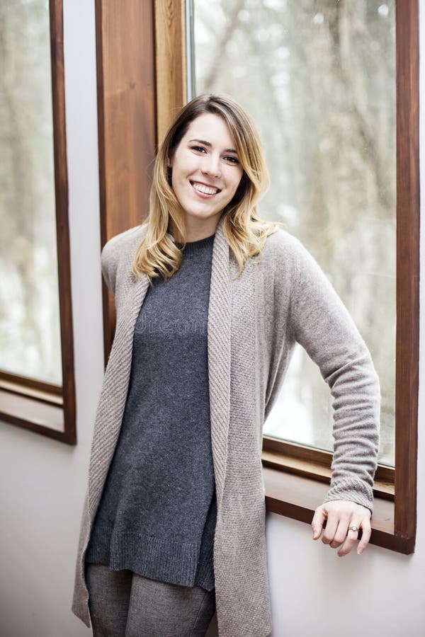 Junge Frau, die sich zuhause im Winter entspannt lizenzfreie stockfotografie Junge Frau, die sich zuhause im Winter entspannt lizenzfreie stockfotografie