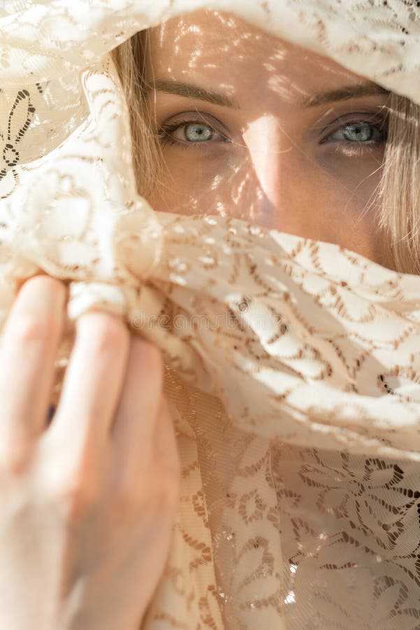 Young woman with blue eyes with scarf over her face. Young woman with blue eyes with scarf over her face.