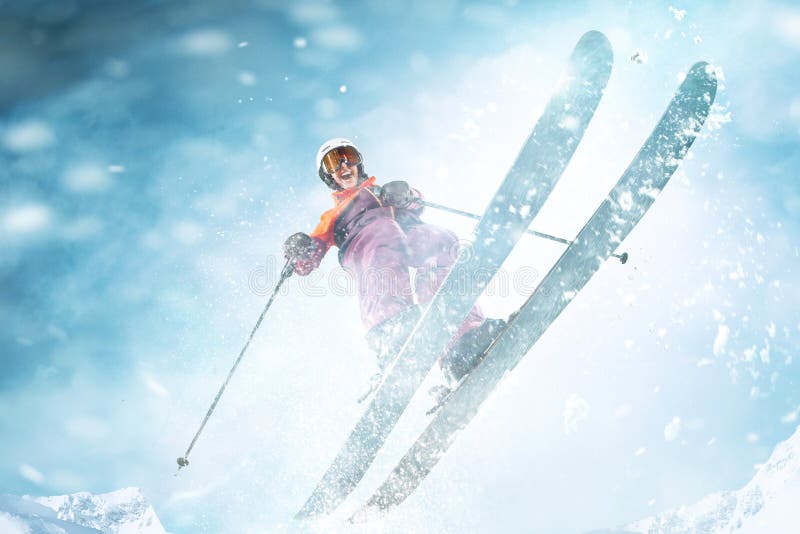 Young beautiful athlete woman doing winter sport - she is skiing against white alps mountain background. Young beautiful athlete woman doing winter sport - she is skiing against white alps mountain background