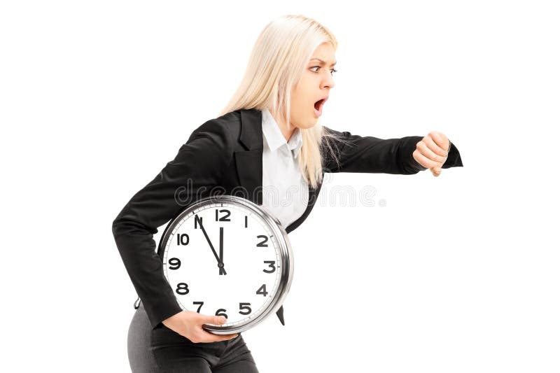 Young businesswoman running late with a wall clock in her hand isolated on white background. Young businesswoman running late with a wall clock in her hand isolated on white background