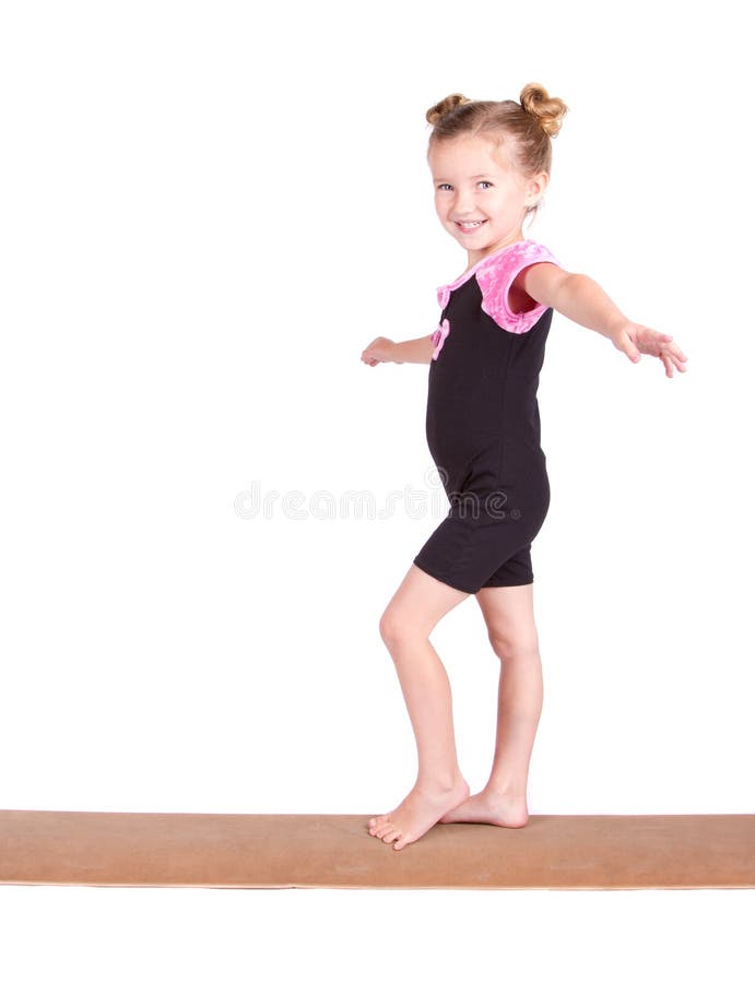 Junge Gymnastschwerpunkte auf Lichtstrahl lizenzfreies stockbild Junge Gymnastschwerpunkte auf Lichtstrahl lizenzfreies stockbild