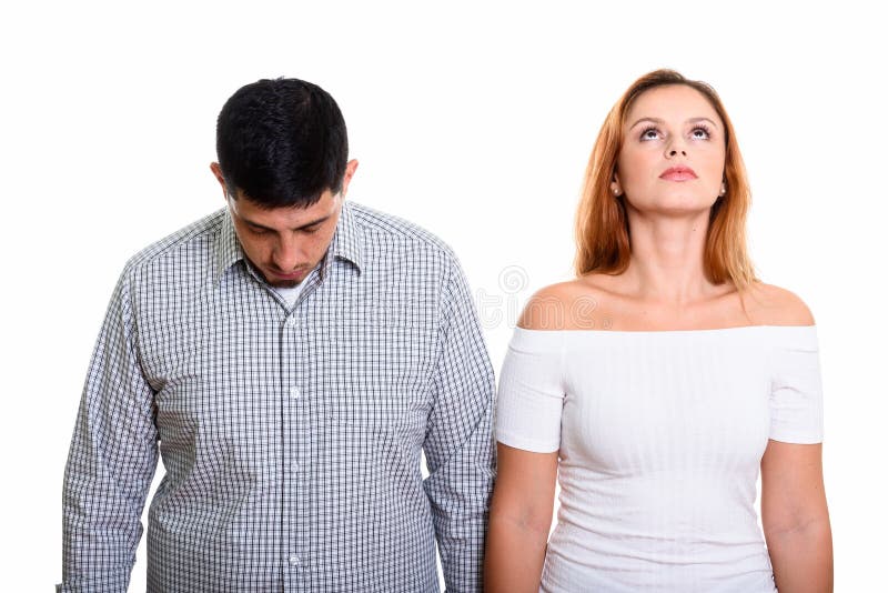 Junge hispanische Paare mit dem Mann, der unten schauen und der Frau, die oben schaut stockfotografie Junge hispanische Paare mit dem Mann, der unten schauen und der Frau, die oben schaut stockfotografie