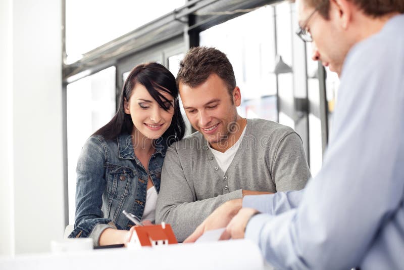 Young couple buying new home. Meeting with architect. Young couple buying new home. Meeting with architect.