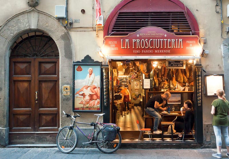 Junge Paare essen im Fleischrestaurant auf historischer Straße alter Toskana-Stadt zu Mittag