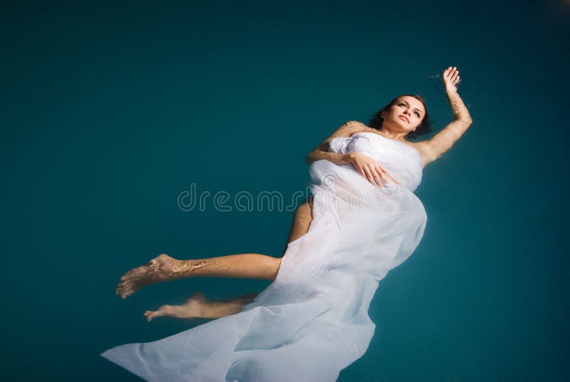 Junge reizvolle Frau, die auf Swimmingpool schwimmt stockfotos Junge reizvolle Frau, die auf Swimmingpool schwimmt stockfotos