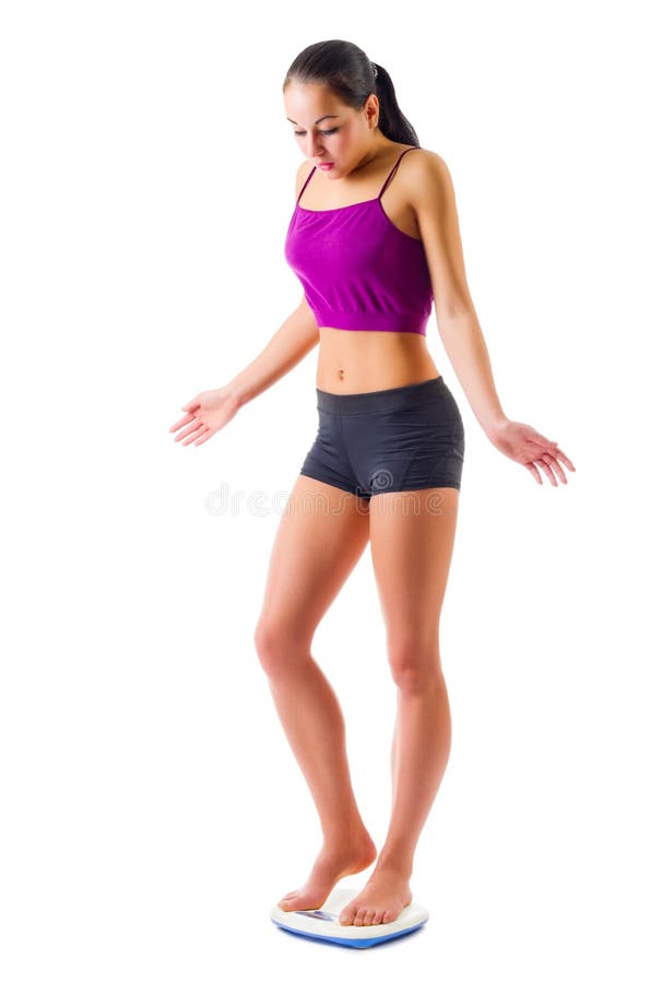 Young sporty woman on scales isolated. Young sporty woman on scales isolated
