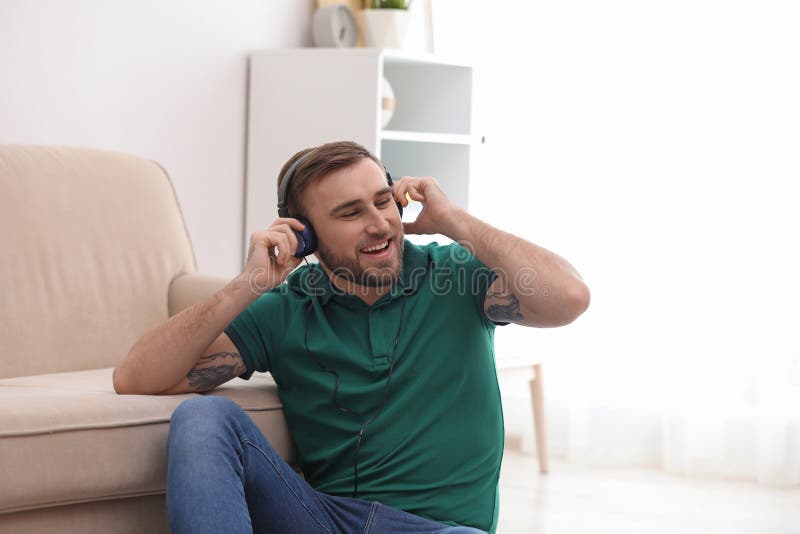 Junger Mann in den Kopfhörern Musik genießend lizenzfreies stockbild Junger Mann in den Kopfhörern Musik genießend lizenzfreies stockbild