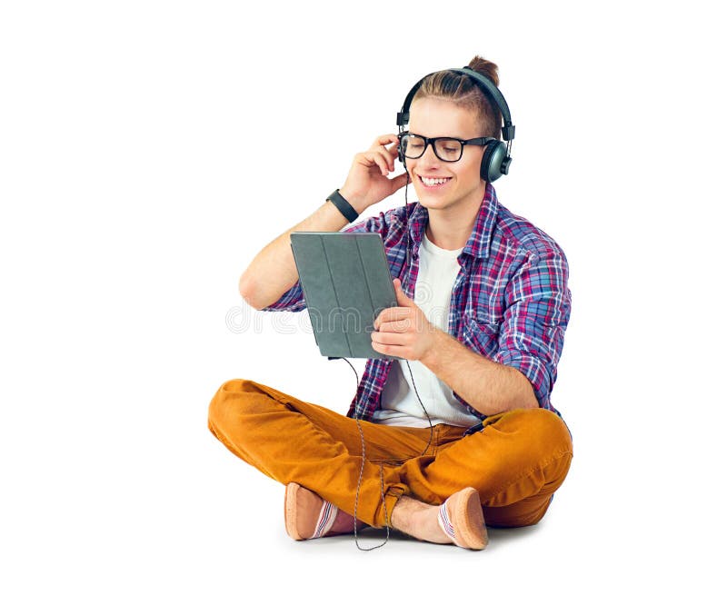 Young fashion man sitting on the floor and enjoying music. Young fashion man sitting on the floor and enjoying music