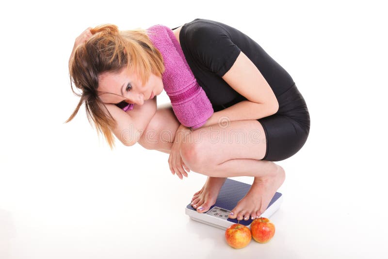 Portrait of young unhappy woman with scale as diet and anorexia concept. Portrait of young unhappy woman with scale as diet and anorexia concept