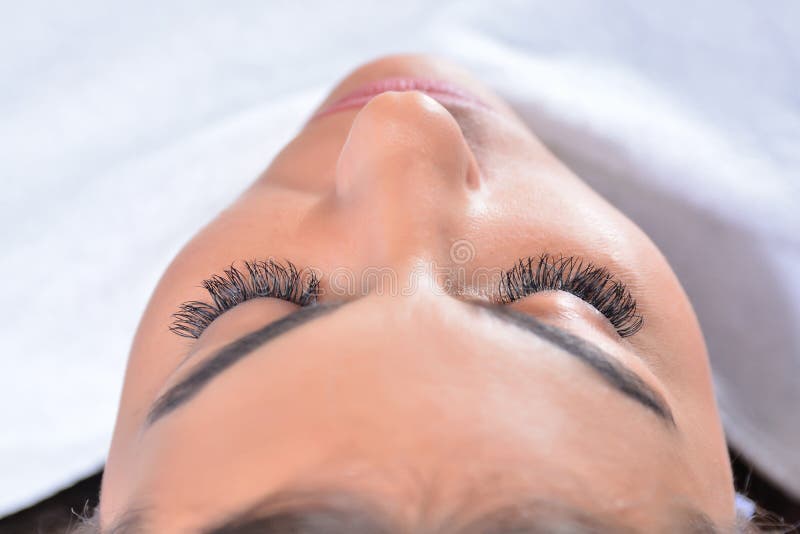 Immerse yourself in a world of beauty and indulgence as a beautiful young woman lies in a cozy salon bed, receiving a luxurious silk eyelash treatment. With closed eyes, she entrusts her lashes to the skilled hands of a beautician, who delicately works to enhance their length, volume, and allure. In this close-up shot with selective focus and a top view perspective, the focus is on the delicate process taking place. The beautician's expert hands meticulously apply the silk lashes, ensuring every lash is perfectly aligned and seamlessly integrated with the natural lashes. The result is a mesmerizing transformation that accentuates the woman's eyes and elevates her natural beauty. The tranquil ambiance of the beauty salon adds to the serene experience. Soft music plays in the background, creating a soothing atmosphere that allows the woman to fully relax and enjoy the treatment. The bed provides a comfortable and inviting space where she can unwind and let the beautician work her magic. Witness the artistry and precision of the beautician as she brings out the full potential of the woman's lashes. From the application of each individual silk lash to the careful consideration of length and placement, every step is taken with meticulous care to ensure a flawless result. Experience the transformative power of a silk eyelash treatment as the woman emerges with stunning lashes that frame her eyes beautifully. The close-up view allows you to appreciate the intricate details of the treatment, capturing the precision and skill involved in enhancing the woman's natural lashes. Indulge in the beauty treatment concept as you embrace the allure and elegance of silk lashes. This image invites you to immerse yourself in the world of beauty, where meticulous care and attention to detail lead to breathtaking results. Immerse yourself in a world of beauty and indulgence as a beautiful young woman lies in a cozy salon bed, receiving a luxurious silk eyelash treatment. With closed eyes, she entrusts her lashes to the skilled hands of a beautician, who delicately works to enhance their length, volume, and allure. In this close-up shot with selective focus and a top view perspective, the focus is on the delicate process taking place. The beautician's expert hands meticulously apply the silk lashes, ensuring every lash is perfectly aligned and seamlessly integrated with the natural lashes. The result is a mesmerizing transformation that accentuates the woman's eyes and elevates her natural beauty. The tranquil ambiance of the beauty salon adds to the serene experience. Soft music plays in the background, creating a soothing atmosphere that allows the woman to fully relax and enjoy the treatment. The bed provides a comfortable and inviting space where she can unwind and let the beautician work her magic. Witness the artistry and precision of the beautician as she brings out the full potential of the woman's lashes. From the application of each individual silk lash to the careful consideration of length and placement, every step is taken with meticulous care to ensure a flawless result. Experience the transformative power of a silk eyelash treatment as the woman emerges with stunning lashes that frame her eyes beautifully. The close-up view allows you to appreciate the intricate details of the treatment, capturing the precision and skill involved in enhancing the woman's natural lashes. Indulge in the beauty treatment concept as you embrace the allure and elegance of silk lashes. This image invites you to immerse yourself in the world of beauty, where meticulous care and attention to detail lead to breathtaking results.