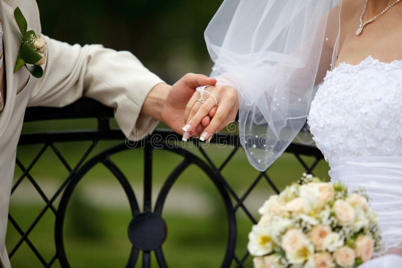 Bride and groom joined their hands. Bride and groom joined their hands