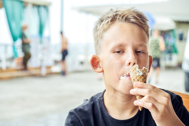 Junior Schoolboy Enjoys Eating Ice Cream and Holidays Stock Image