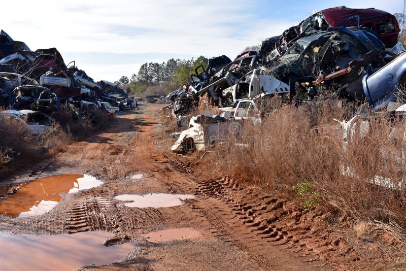 A stacked pile of old junked cars stripped of parts and ready for recycling. A stacked pile of old junked cars stripped of parts and ready for recycling.