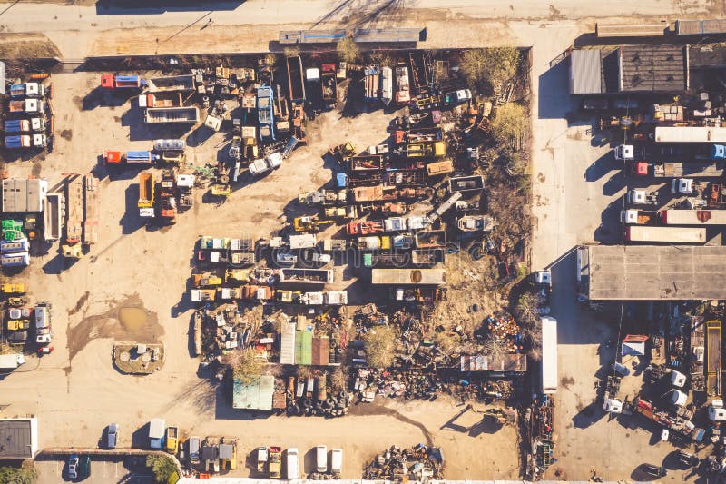 Junkyard with cars abandoned and rusting.