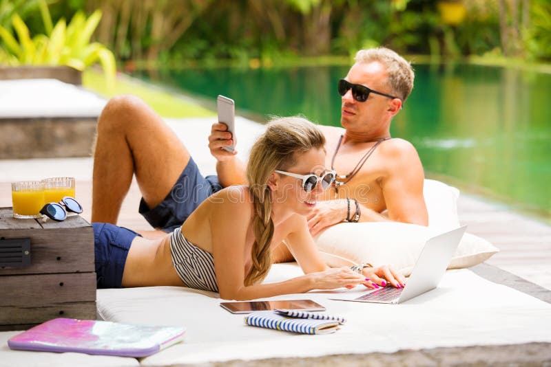 Stress free couple relaxing in hot summer day and using tech. Stress free couple relaxing in hot summer day and using tech