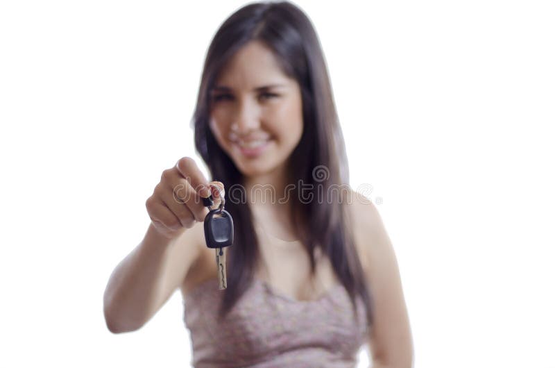 Cute young woman handing over a set of car keys to its new owner. Cute young woman handing over a set of car keys to its new owner