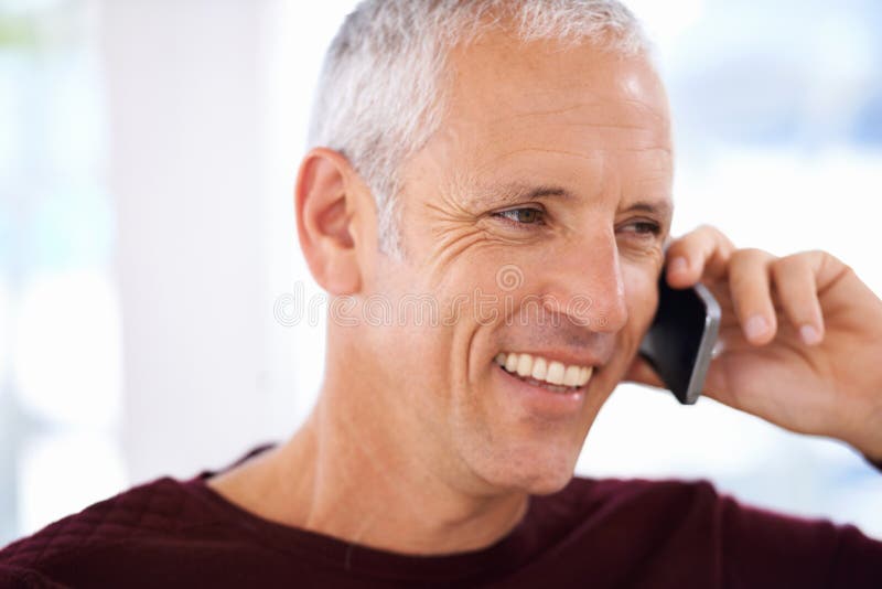 Just Hearing that Voice Brings a Smile a Mature Man Laughing Over the Just Hearing that Voice Brings a Smile a Mature Man Laughing Over the