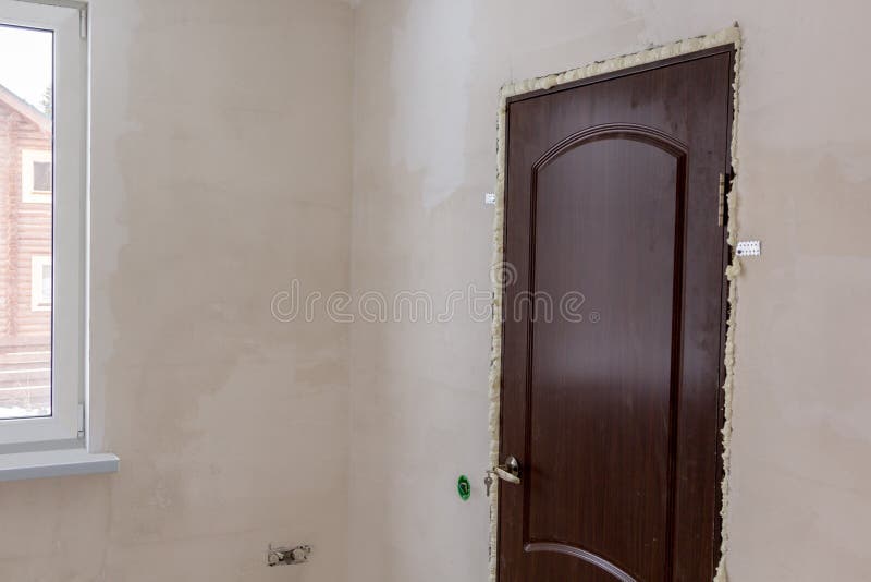 Just Installed Door in Door Opening Filled with Foam Stock Photo